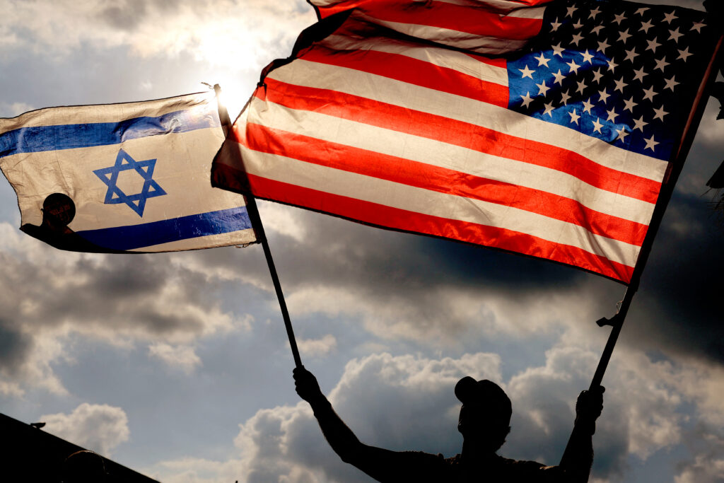 A protester waves US and Israeli national flags during a demonstration in front of the US embassy in Tel Aviv, as Israel's Prime Minister Benjamin Netanyahu is in New York to meet President Joe Biden, on September 20, 2023. US President Joe Biden and Prime Minister Benjamin Netanyahu tried to smooth over months of tensions as they met for the first time on September 20, since the Israeli's reelection in December. (Photo by JACK GUEZ / AFP)